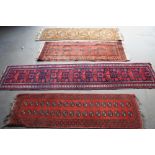 Four Middle Eastern hand made wool runners all with geometric designs, largest 114 x 24 ins.