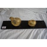 A pair of Oriental brass grouse on an ebonised pedestal, height 4 ins.