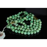 Chinese double string green jadeite bead necklace and bracelet with 9ct gold clasps (