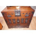 Mid 19thC Korean elm Tansu with iron mounts and hinges, heavy studs and original lock on shaped base