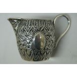 Small Victorian ornate chased silver cream jug. Birmingham 1888 1.5ozt