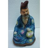 Chinese porcelain seated figure of the Mad Monk, impressed mark to base on carved wood stand