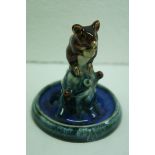 Royal Doulton Lambeth Mouse holding a nut, sitting on a branch with circular base. No.8673. Ht. 4