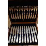 Canteen of mother of pearl handled dessert knives and forks with engraved decoration to the blades