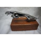 Jaguar car mascot mounted on a mahogany block