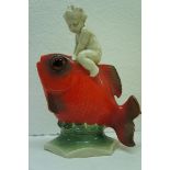 Mid 20thC German porcelain nursery lamp in the form of a child riding on the back of a carp with