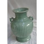 A Chinese Celadon porcelain two handled baluster vase with ribbed body and under glaze blue mark