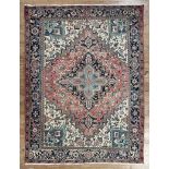 Persian Heriz Carpet, red, blue and cream ground, serrated spandrels and medallions, 7 ft. 3 in. x 9