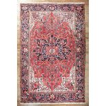 Persian Heriz Carpet, central medallion in red and blue, floral border, 8 ft. 7 in. x 11 ft. 7 in