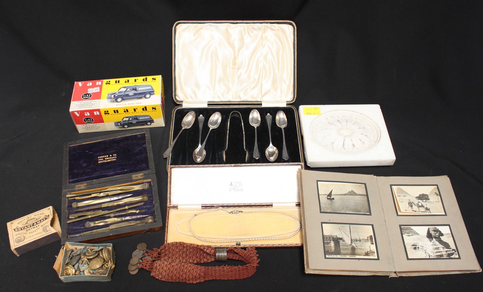 A collection of assorted items including a carved marble tile, a set of draghtsmans tools, an