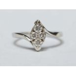 An 18ct white gold and diamond four stone ring, in a marquise shaped setting, in original