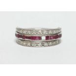 A diamond, ruby and sapphire hinged ring, set in white gold or platinum. Size J.