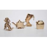 Four various 9ct gold charms including a bell, a teapot, a dog and an Egyptian head. Gross weight