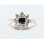 An 18ct gold, diamond and sapphire daisy cluster ring, the central sapphire surrounded by eight