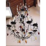 A large modern wrought iron and glass drop chandelier, strung with prism cut and coloured glass