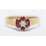 An 18ct gold, diamond and ruby daisy cluster ring. 3.8 grams. Size Q.