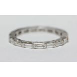 A platinum and baguette diamond full-eternity ring, end-to-end pave-set with eighteen baguette-cut