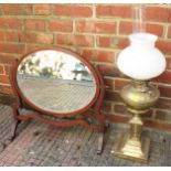 An Edwardian oval bevelled edge swinging dressing table mirror 36 x 46cm, together with a brass