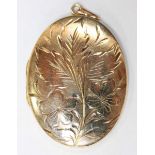 ADDENDUM: GOLD PLATED, '9CT BACK AND FRONT' A 9ct gold oval pendant locket with engraved flowers,