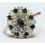 A 9ct gold, sapphire, diamond and opal cluster ring.