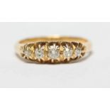 An 18ct gold claw set five stone diamond ring with pierced mount,the diamonds approximate weight a