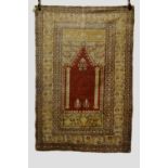 Ghiordes prayer rug, west Anatolia, early 20th century, 5ft. 6in. x 3ft. 9in. 1.68m. x 1.14m.