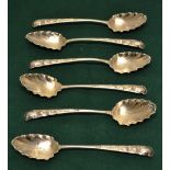A set of six silver decorative dessert spoons, with repousse foliage and crested handles, leaf