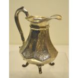 An early Victorian silver cream jug, the engraved octagonal panelled body with a moulded scroll
