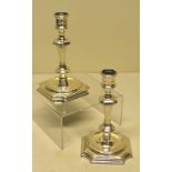 A pair of eighteenth century Irish cast silver candlesticks, the baluster stems with girdled urn