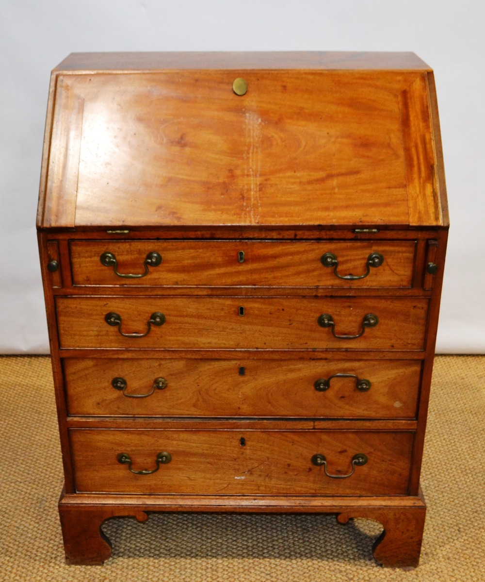 A small George III mahogany bureau, the fall flap reveals a fitted interior above four long