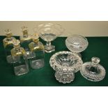A set of four early nineteenth century glass liquer decanters with gilt decorated shoulders fluted m