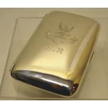 A late Victorian silver cigar case, hip shaped and engraved a spreadeagle crest above a motto and