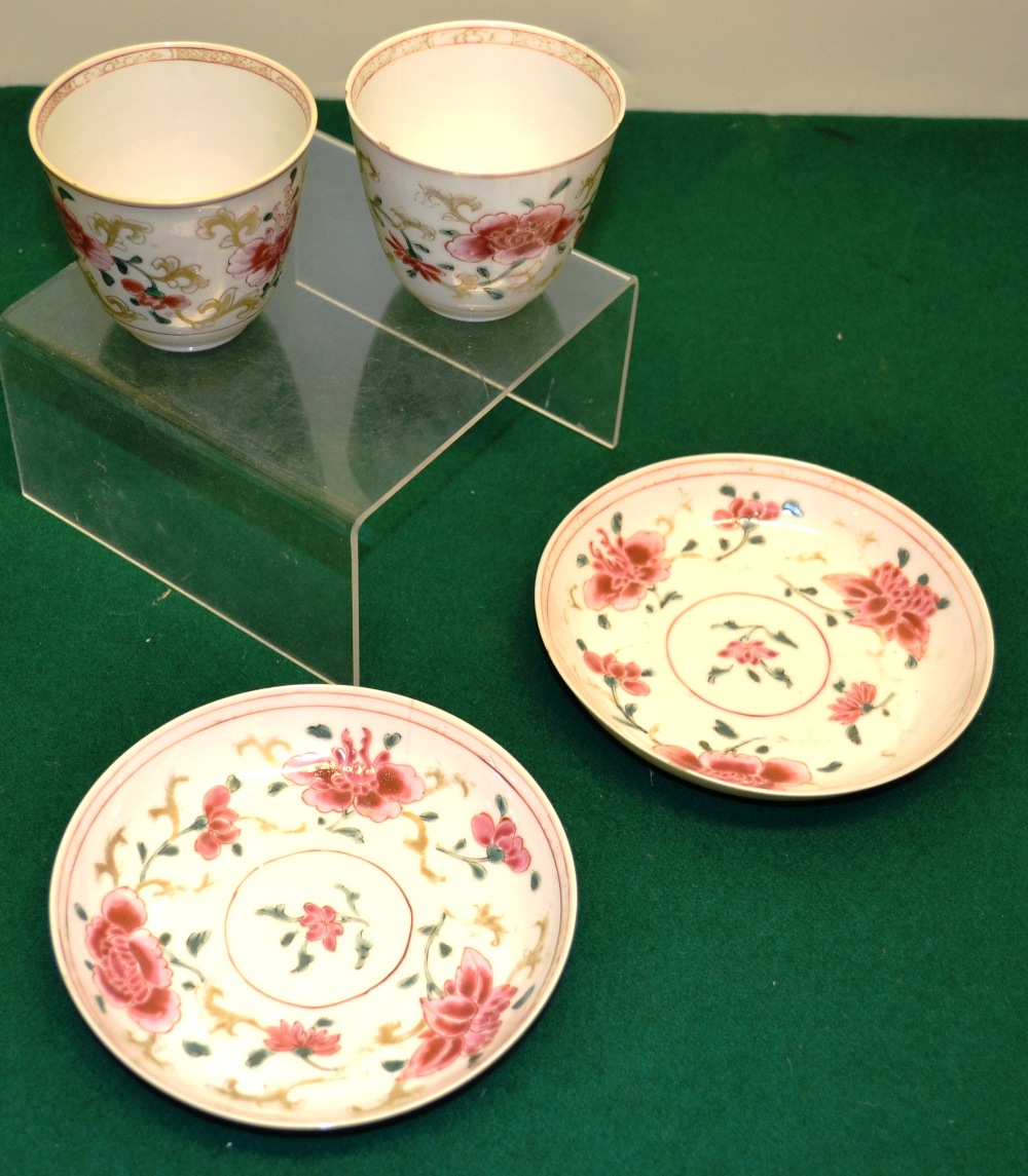 A pair of eighteenth century Chinese famille rose porcelain beakers and saucers, decorated foliage w