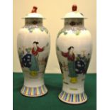 A pair of Chinese porcelain First Republic vases and covers, decorated in coloured famille rose