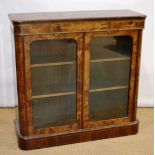 A nineteenth century Franglais walnut veneered side cabinet, with chased brass mouldings and