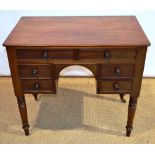 A William IV mahogany kneehole dressing table, fitted six drawers with wood knob handles, an