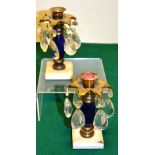 A pair of early nineteenth century boudoir candlesticks, the ormolu mounted blue glass stems on
