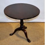 A mid eighteenth century Cuban mahogany occasional table, the circular tilt top on a baluster stem t