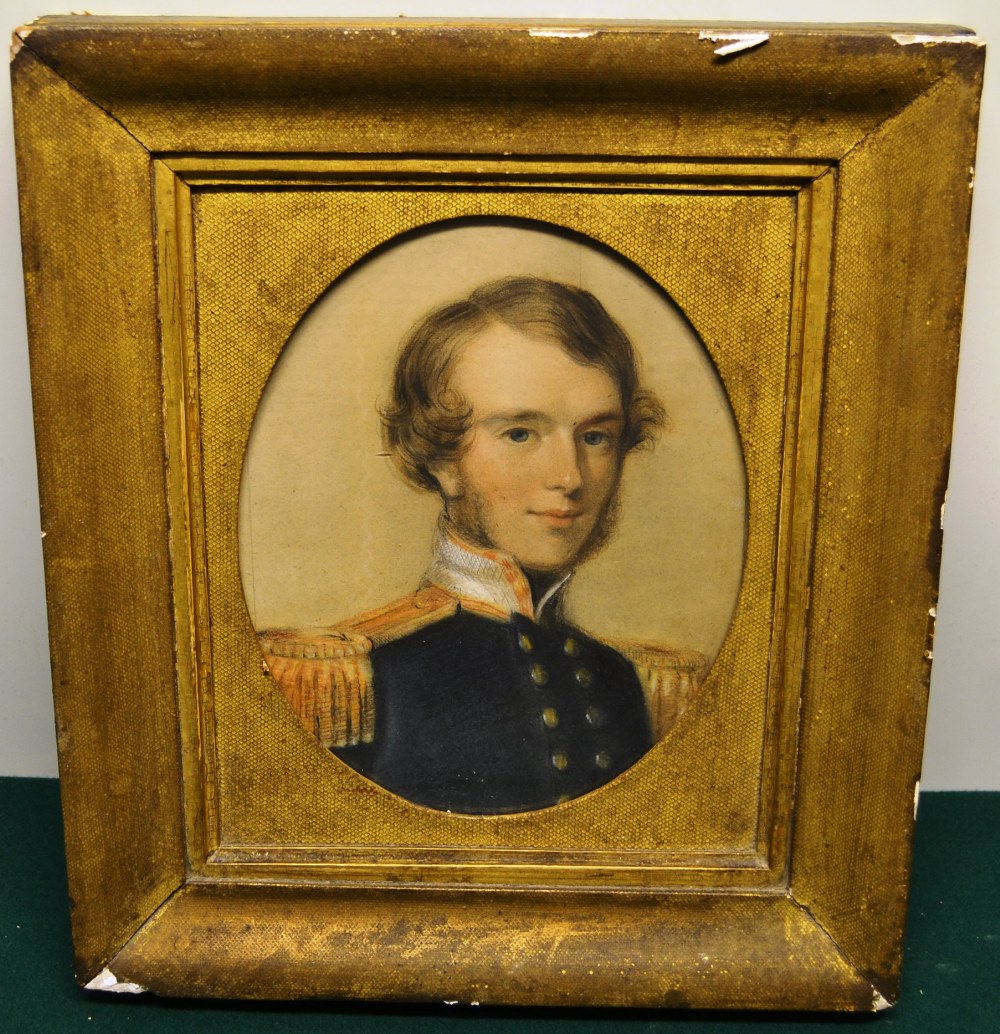 A Victorian oval crayon portrait of a young Naval Officer. 9.25in (23.5cm) x 7.25in (18.5cm) in a
