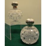 A pair of Victorian hobnail cut glass scent bottles with spiral fluted screw on covers and glass