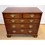 A George III mahogany chest, of two short and three long graduated drawers with replaced pierced
