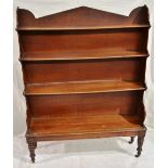An early nineteenth century mahogany waterfall open bookcase, with a pediment to the top shelf,