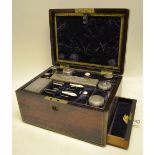 An early Victorian lady's rosewood veneered travelling toilet box, brass bound and inlaid