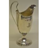 A George III silver vase shape cream jug, engraved a crest of a bulls head above a coronet, beaded