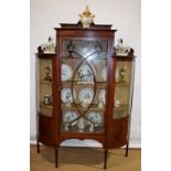 An Edwardian mahogany china cabinet, banded in satinwood and inlaid stringing, the stepped top