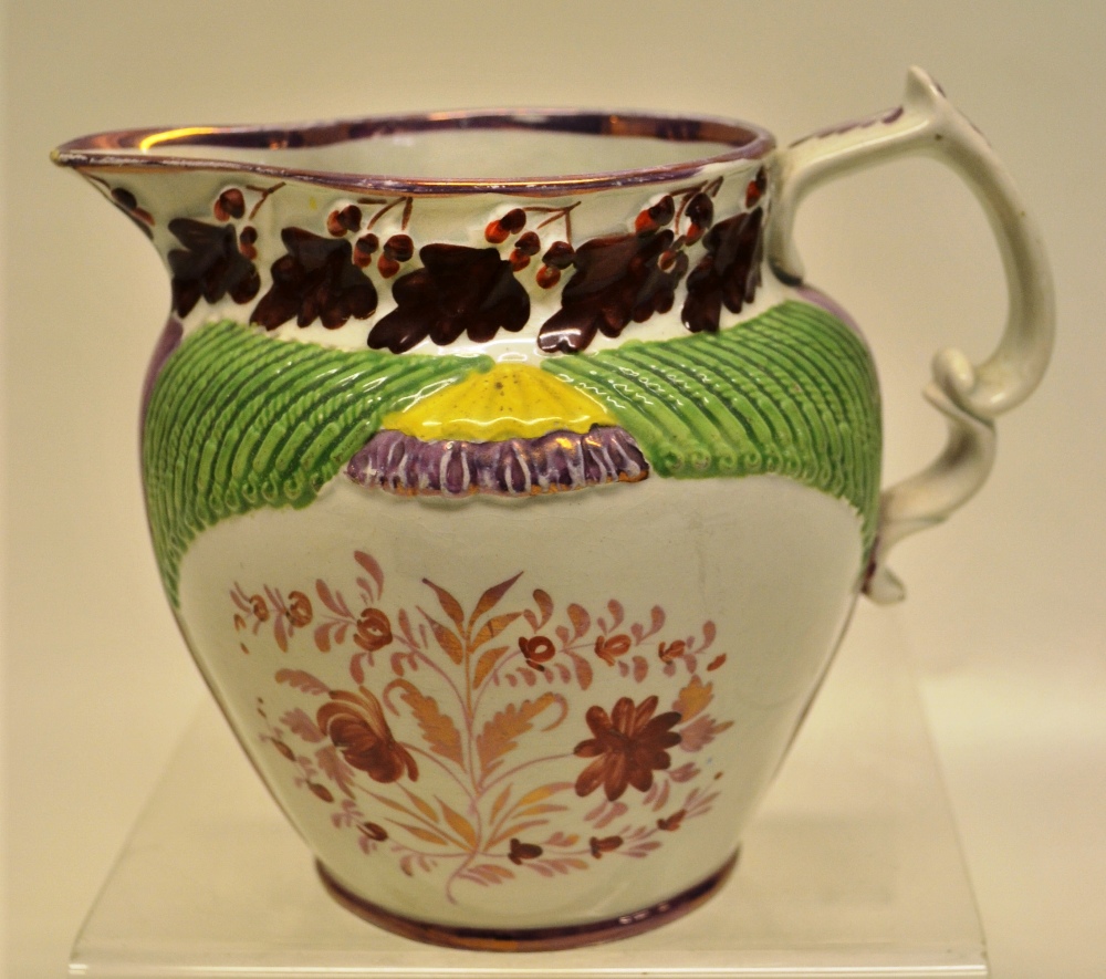 An unusual early nineteenth century prattware jug, with ribbed moulded tapering above flowers,