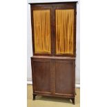 A small mid nineteenth century mahogany cabinet, the top with a cornice above two shelves,