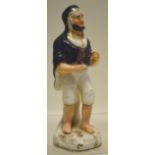 An early nineteenth century Staffordshire figure of a prophet, wearing a blue cape and carrying a