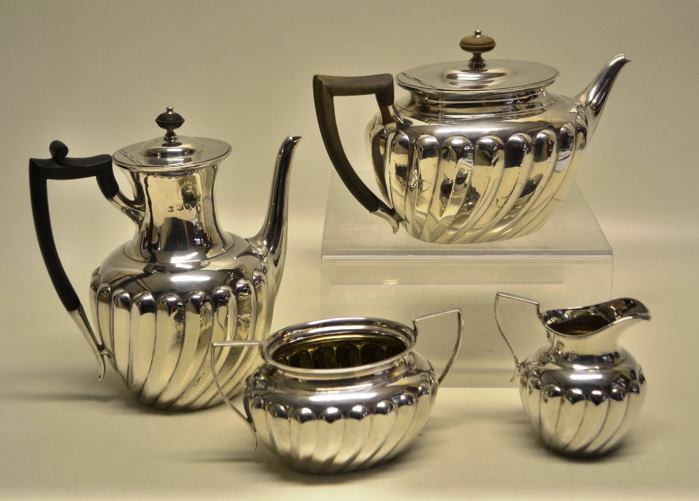A late Victorian silver four piece tea and coffee service, the bodies partly ribbed having