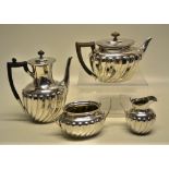 A late Victorian silver four piece tea and coffee service, the bodies partly ribbed having